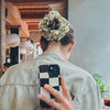 Back view of girl in high bun wearing Maven Ruffle Scrunchie - spring colours of yellow and green