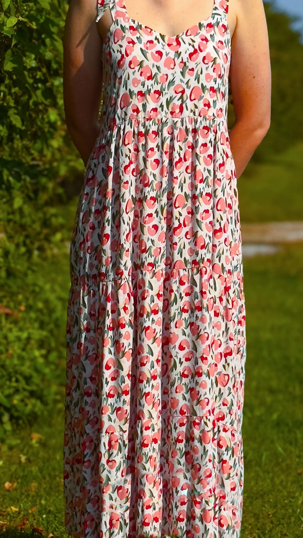 Young caucasian woman wearing pink & red floral Maven Maxi Sundress (front view)
