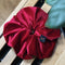 Soft velvet oversized scrunchie in deep cherry red with leaf