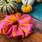 Oversized silk pink & orange scrunchie with pumpkins in the background