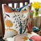 Abstract floral cushion in browns, blues and reds