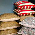 Beige, red striped and pink cushions