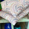 Embroidered stone-coloured linen handmade cushion covers with blue vases